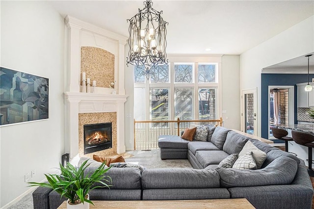 living area featuring carpet and a high end fireplace