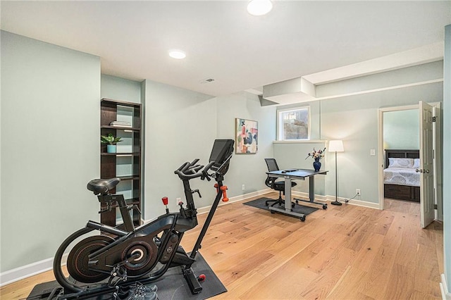 workout area with wood finished floors and baseboards