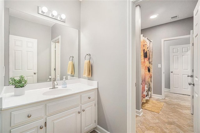 bathroom featuring visible vents, baseboards, a shower with curtain, and vanity