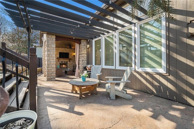 view of patio / terrace with a pergola and an outdoor stone fireplace