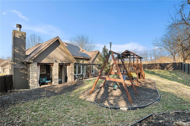 view of playground with a yard and a fenced backyard