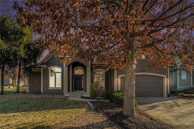 view of property hidden behind natural elements featuring a front yard, concrete driveway, and an attached garage