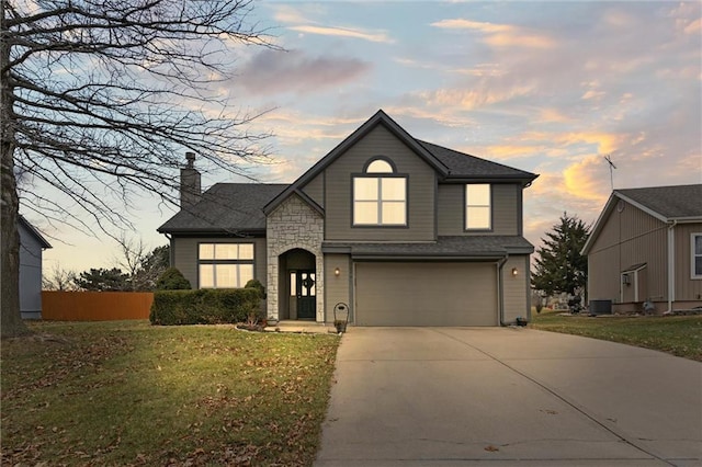 view of front of home with a garage, a lawn, and central air condition unit