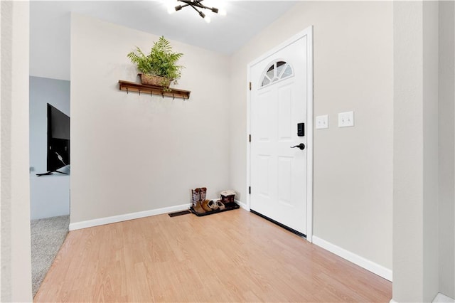 entrance foyer featuring wood finished floors and baseboards