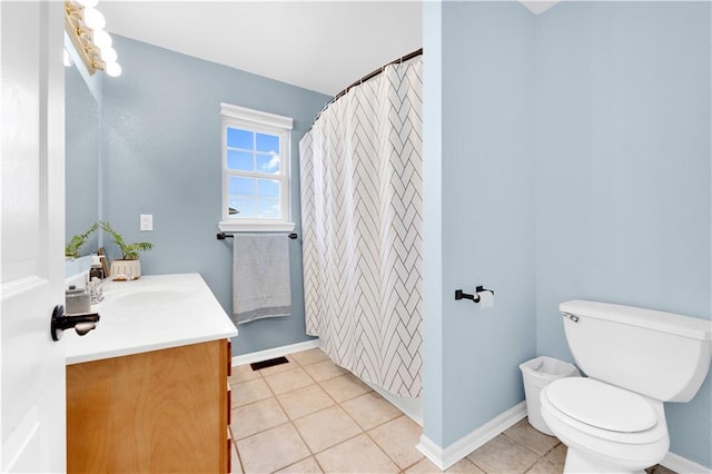 bathroom with toilet, tile patterned flooring, baseboards, and vanity