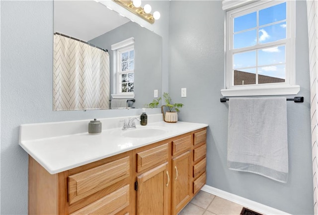 bathroom featuring baseboards, visible vents, vanity, and tile patterned floors