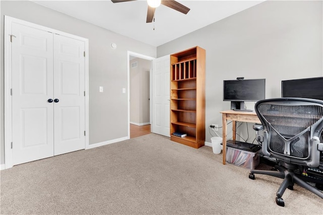 carpeted office space with ceiling fan, visible vents, and baseboards