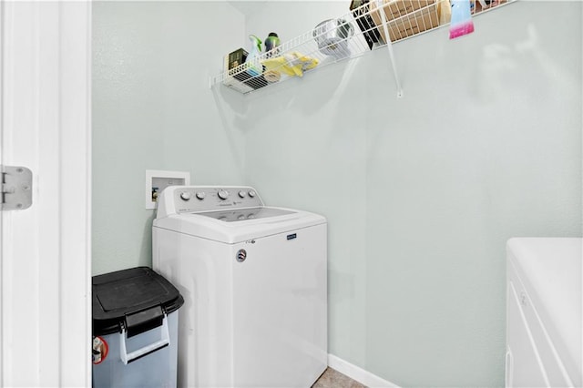 laundry area featuring laundry area, independent washer and dryer, and baseboards