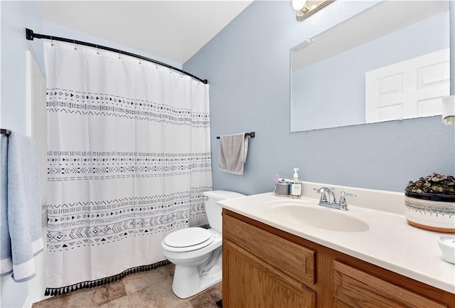 bathroom featuring a shower with shower curtain, vanity, toilet, and tile patterned floors