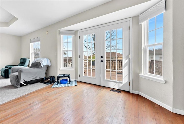 entryway featuring french doors, visible vents, baseboards, and hardwood / wood-style flooring