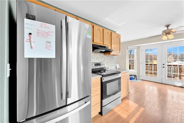 kitchen with stainless steel appliances, light brown cabinets, plenty of natural light, and under cabinet range hood