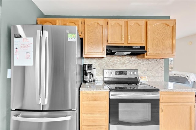 kitchen with appliances with stainless steel finishes, light brown cabinets, under cabinet range hood, and tasteful backsplash