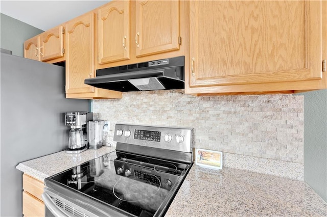 kitchen with appliances with stainless steel finishes, light countertops, under cabinet range hood, and light brown cabinetry