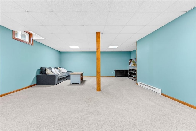 living area with a baseboard heating unit, carpet, a drop ceiling, and baseboards