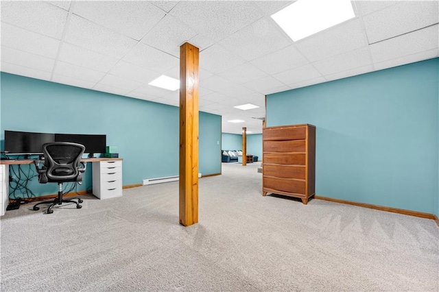 office space featuring carpet, a drop ceiling, and baseboards