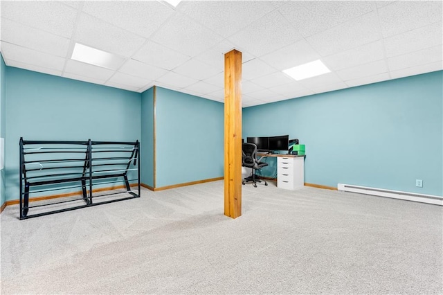 office area with carpet floors, a baseboard radiator, baseboards, and a drop ceiling