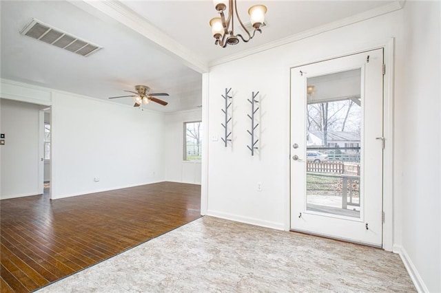 interior space with visible vents, crown molding, baseboards, ceiling fan with notable chandelier, and wood finished floors