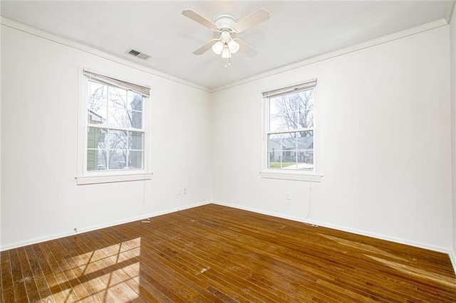 unfurnished room with wood-type flooring, a ceiling fan, visible vents, and a wealth of natural light