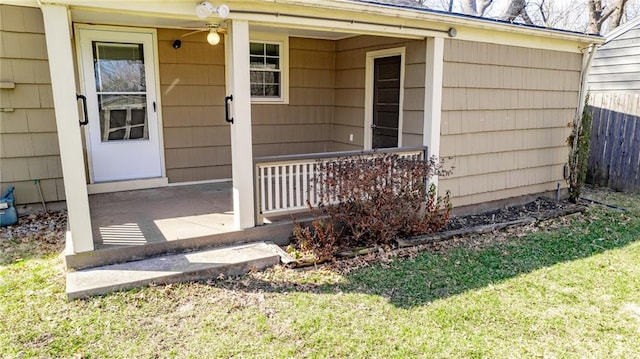 property entrance with a porch and a yard