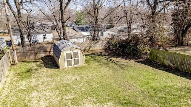 view of yard featuring a fenced backyard, a shed, and an outdoor structure