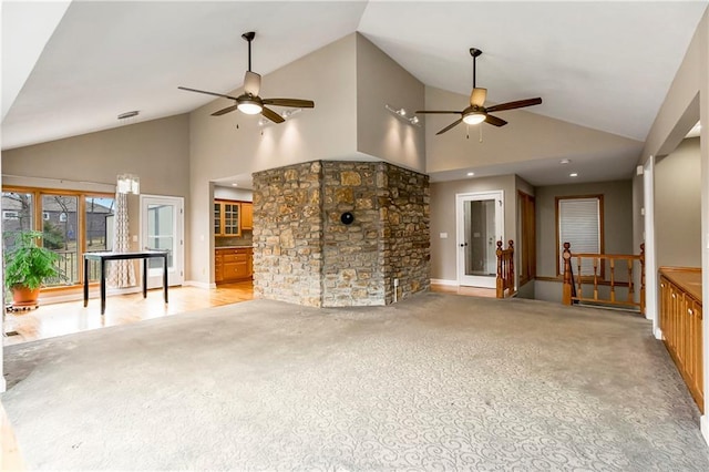 unfurnished living room with a ceiling fan, carpet floors, and high vaulted ceiling