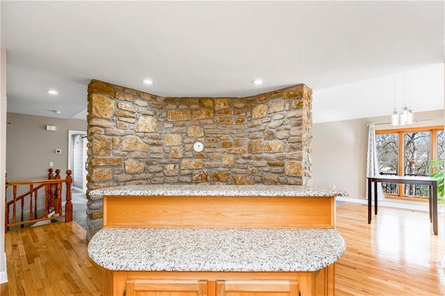 interior space featuring recessed lighting, light wood-style floors, baseboards, and light stone countertops