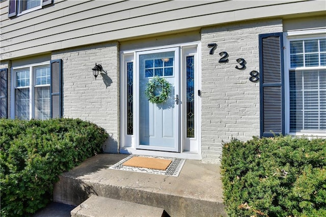 property entrance with brick siding