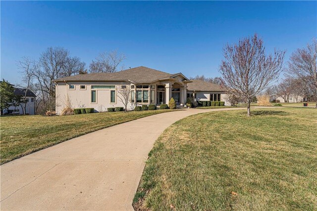 view of front of house with a front yard and stucco siding