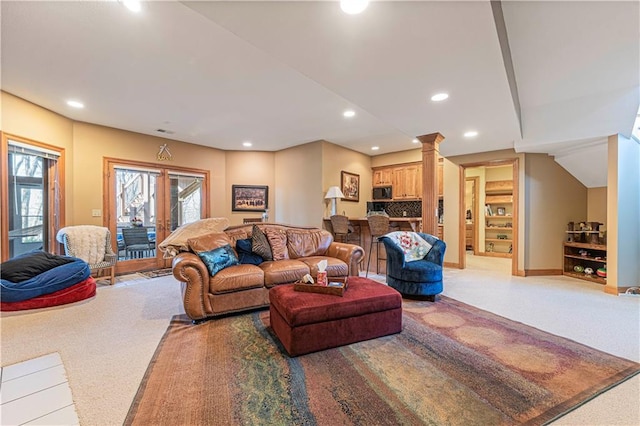 living room with recessed lighting, light colored carpet, baseboards, and decorative columns