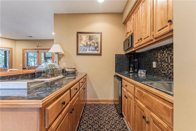 kitchen with tasteful backsplash, black microwave, baseboards, dishwasher, and tile counters