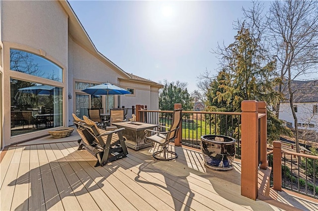 wooden deck featuring an outdoor fire pit