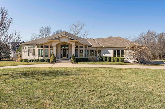 view of front of home featuring a front yard and stucco siding