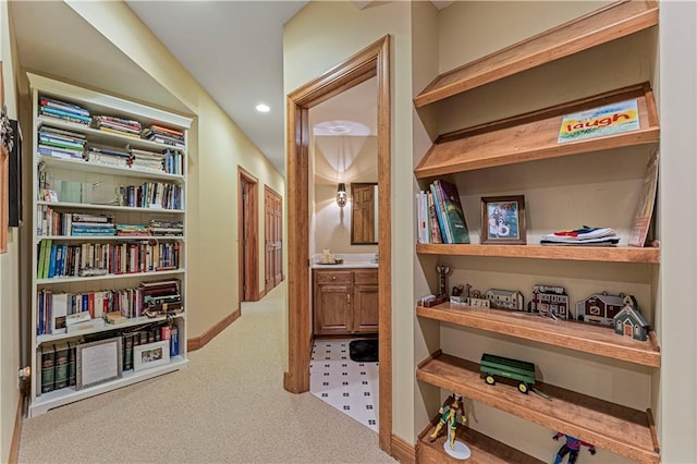 hallway featuring recessed lighting and baseboards