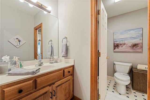 bathroom featuring toilet and vanity