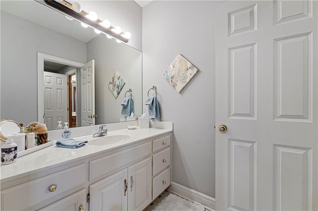 bathroom with vanity and baseboards