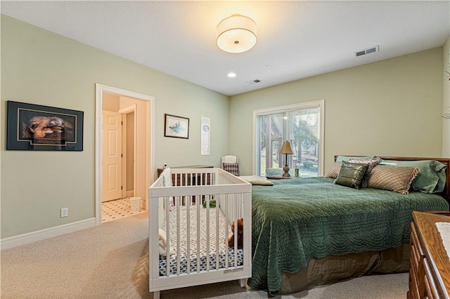 carpeted bedroom featuring visible vents and baseboards