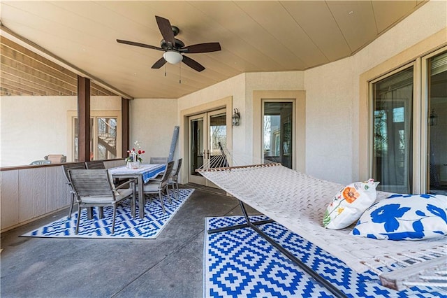 view of patio featuring outdoor dining space and a ceiling fan