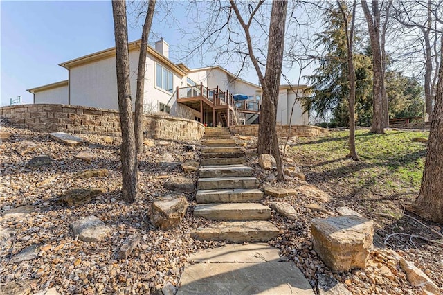 view of yard with stairway and a wooden deck