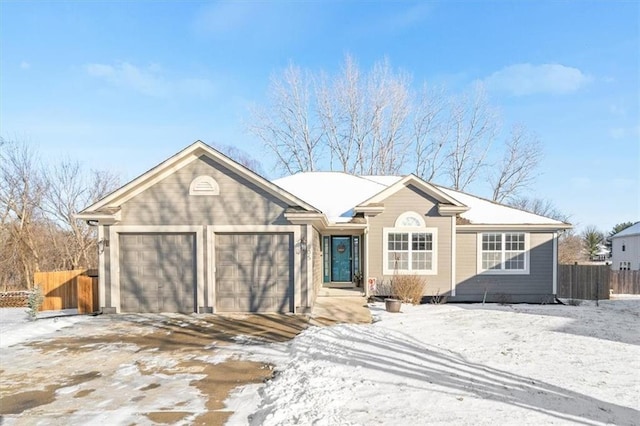 ranch-style home with a garage and fence