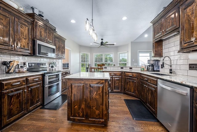 22330 Mclouth Rd, Mclouth, KS 66054 - kitchen with light stone countertops, appliances with stainless steel finishes, dark wood-style flooring, and a sink
