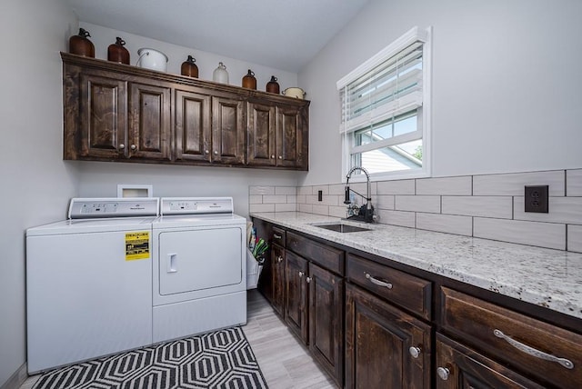22330 Mclouth Rd, Mclouth, KS 66054 - laundry area with independent washer and dryer, a sink, and cabinet space