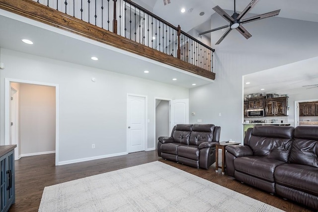 22330 Mclouth Rd, Mclouth, KS 66054 - living room with ceiling fan, recessed lighting, a high ceiling, baseboards, and dark wood-style floors
