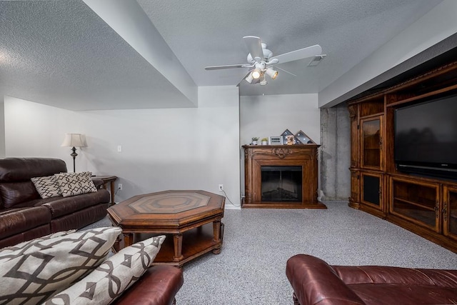 22330 Mclouth Rd, Mclouth, KS 66054 - living room with a fireplace with raised hearth, ceiling fan, a textured ceiling, and visible vents