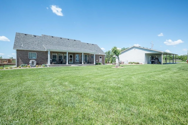22330 Mclouth Rd, Mclouth, KS 66054 - rear view of property featuring brick siding, a yard, and a patio
