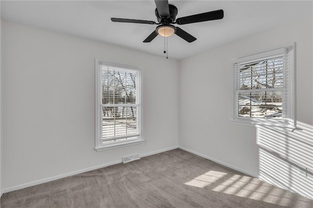 empty room featuring light carpet and ceiling fan