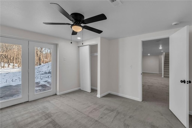 unfurnished bedroom featuring access to exterior, light colored carpet, and ceiling fan