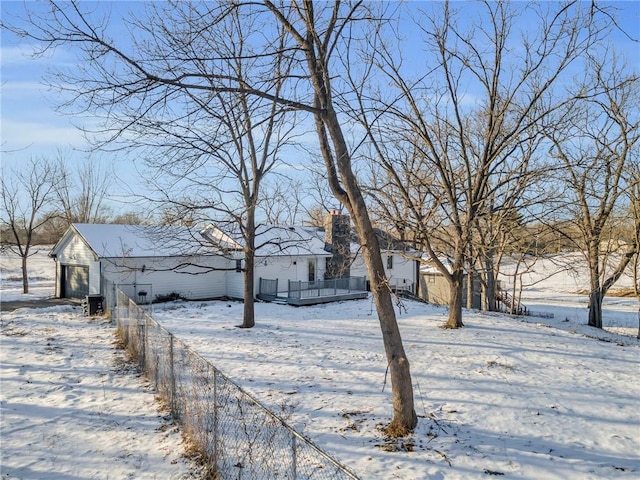 yard covered in snow with a garage