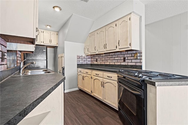 kitchen with black appliances, a sink, backsplash, dark countertops, and dark wood-style floors