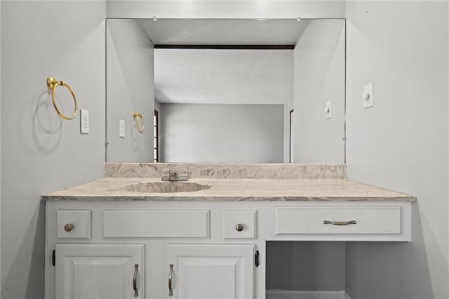 bathroom with vanity and a textured ceiling