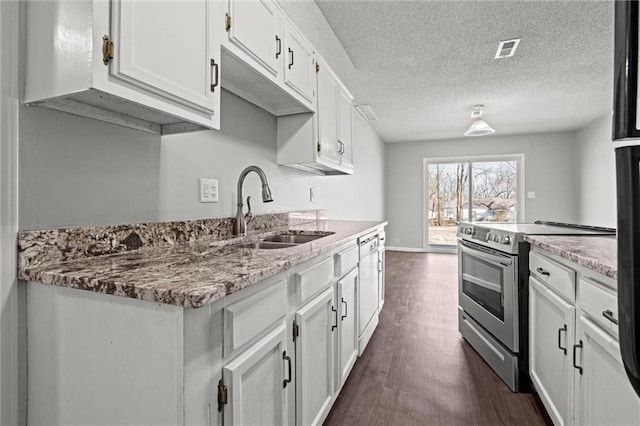 kitchen featuring visible vents, white cabinetry, stainless steel electric range oven, and a sink